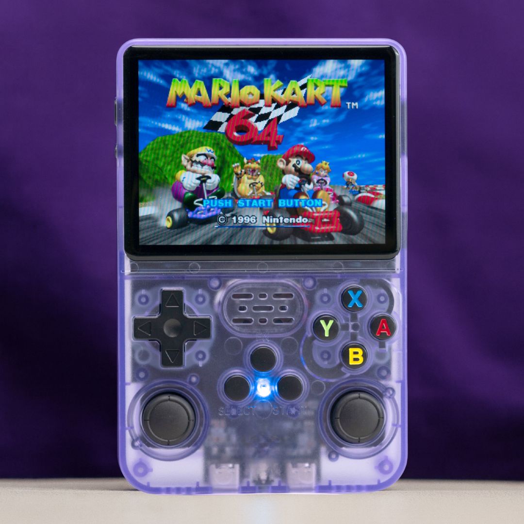 Handheld gaming console with a transparent purple case displaying 'Mario Kart' on the screen against a purple background.
