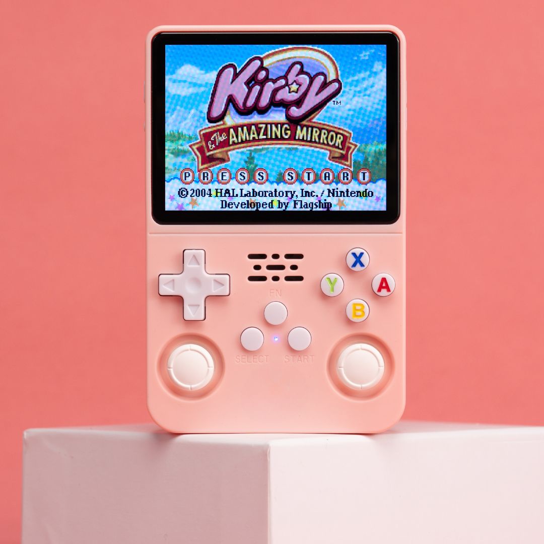 Pink handheld gaming console displaying 'Kirby: The Amazing Mirror' on a pink background