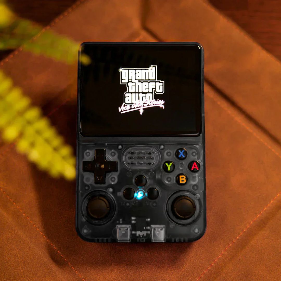 Handheld gaming console with 'Grand Theft Auto' logo on a brown surface